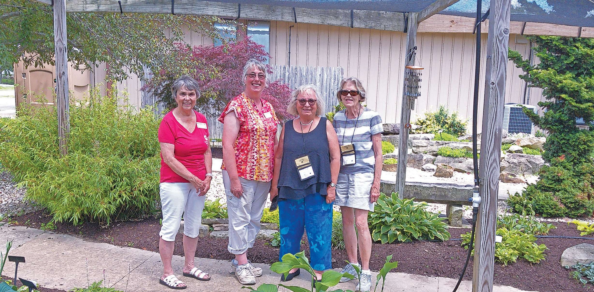 Four Farm Boys Tour participants at Friendship Gardens in Kenton
