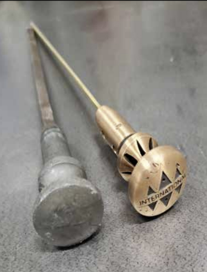Photo Caption: The old oil dipstick (left) swollen from oil contact, and the new dipstick (right) with o-ring and logo